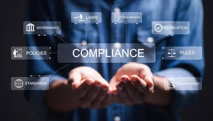 Hands under a virtual "Compliance" interface with terms like laws, governance, policies, and rules in concern of compliance and risk management