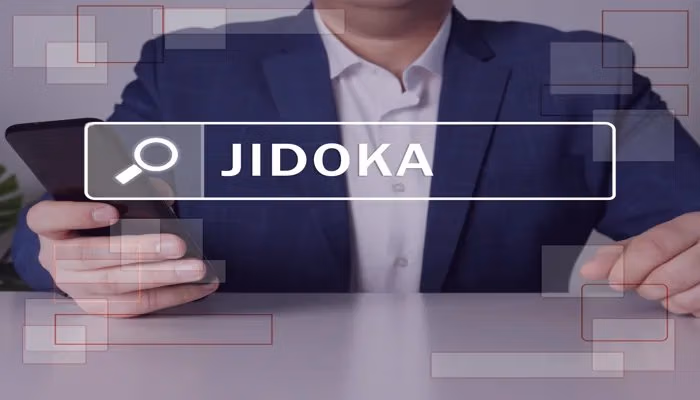 Business person holding a smartphone with the term Jidoka in focus