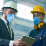 Two engineers discussing a HAZOP study in the manufacturing industry