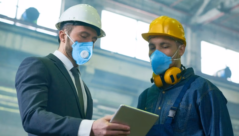 Two engineers discussing a HAZOP study in the manufacturing industry