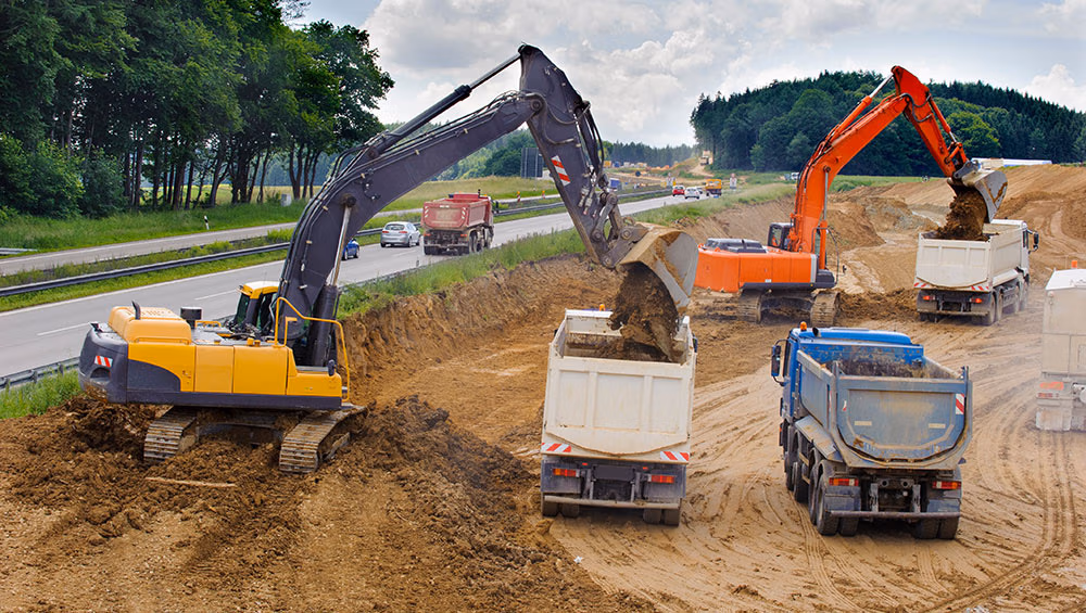 highway construction excavator that excavates dirt for a road