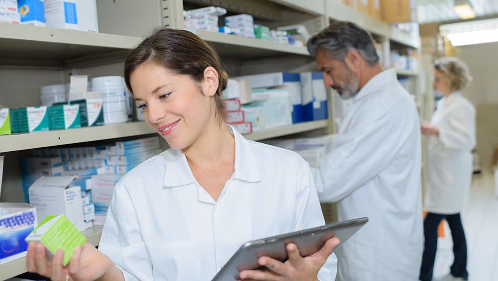 pharmacist checks medications with her iPad